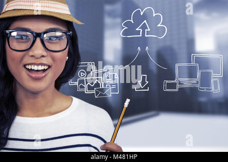 Composite image of attractive asian woman with hat holding pencil Stock Photo