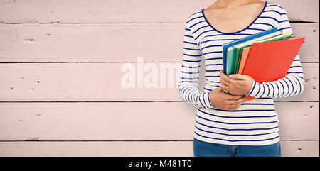 Composite image of mid section of woman holding files Stock Photo