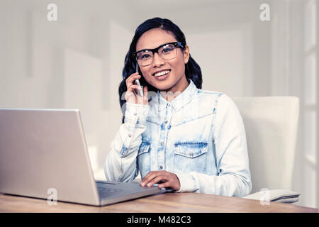 Composite image of asian woman on a phone call Stock Photo
