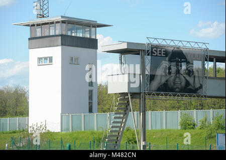 Command tower and observation bridge with picture of GDR border guard See you in former control point and passport control booths of Grenzubergangsste Stock Photo