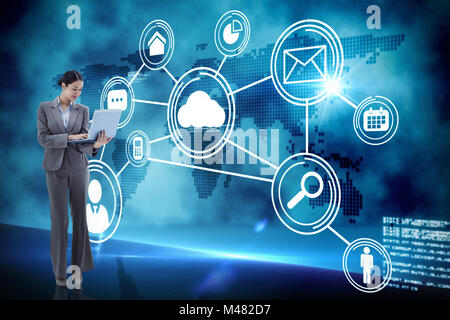 Composite image of portrait of a businesswoman using a laptop Stock Photo