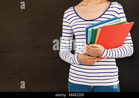 Composite image of mid section of woman holding files Stock Photo