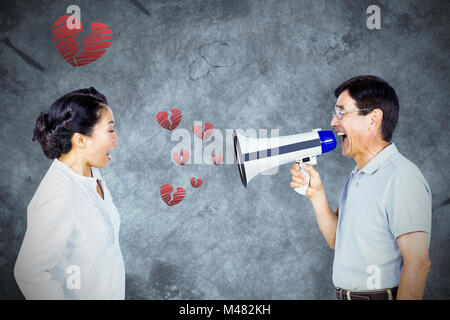 Composite image of man shouting at his partner through megaphone Stock Photo