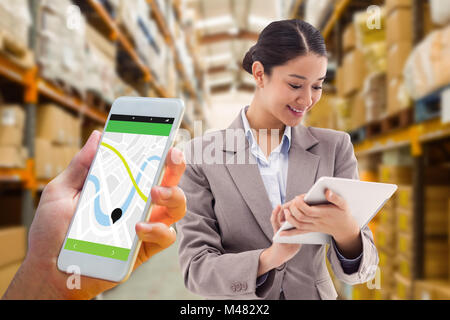 Composite image of hand holding smartphone Stock Photo