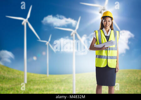 Composite image of architect woman with yellow helmet and plans Stock Photo