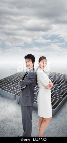 Composite image of portrait of business people standing back-to-back Stock Photo