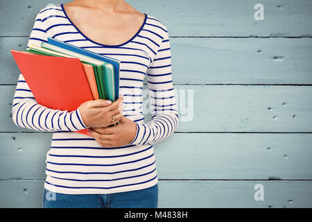Composite image of mid section of woman holding files Stock Photo