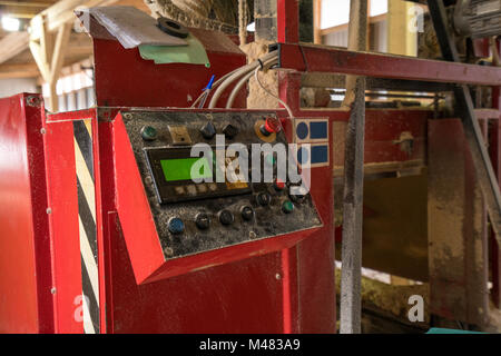 Control panel covered with sawdust at sawmill Stock Photo