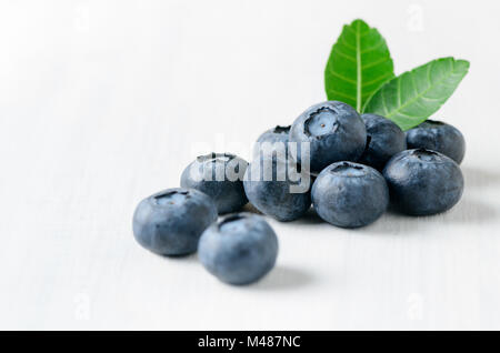fresh blueberry fruits with leaf on white wood background, healthy friuts concept Stock Photo