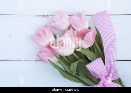 Beautiful bouquet of pink tulips on light wooden background Stock Photo