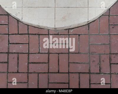 Urban pavement: pink pavement square tile, top half a circle of white tiles. Stock Photo