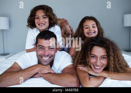 Portrait of family lying on top of each other Stock Photo