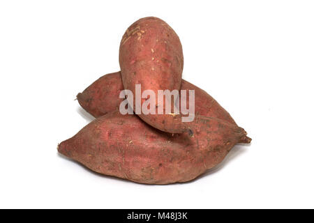 A pile of raw sweet potatoes on a white background Stock Photo