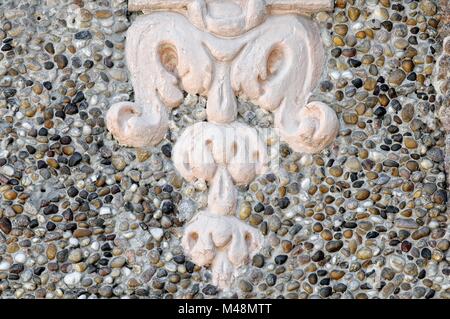 Stucco ornament on exposed aggregate concrete background Stock Photo
