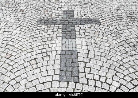 postponed the Holy Cross with granite paving in the ground Stock Photo