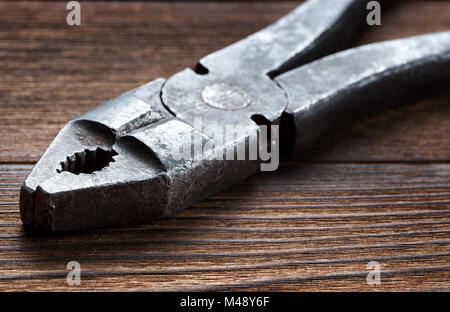 old rusty pliers on wooden background Stock Photo
