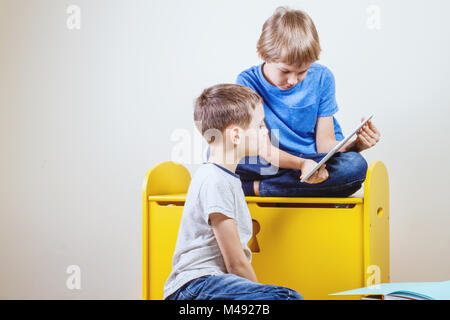 Children playing on tablet at home Stock Photo