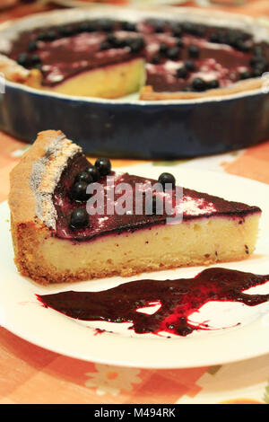 pie with bilberry on the plate and cup of tea Stock Photo