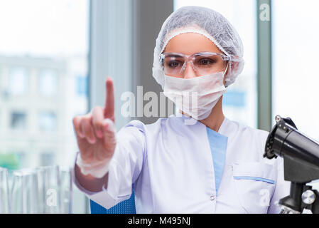 Young student working with chemical solutions in lab Stock Photo