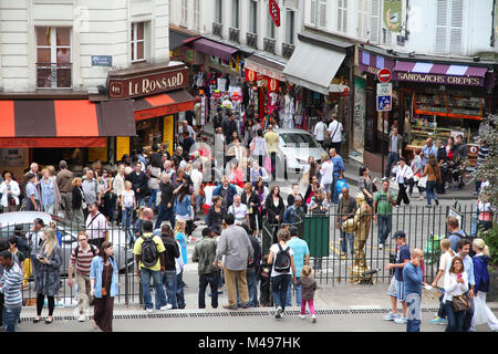 PARIS, FRANCE - JULY 22, 2011: Tourists stroll in Montmartre district in Paris, France.  Paris is the most visited city in the world with 15.6 million Stock Photo