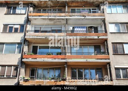 Vidin, Bulgaria - old communist apartment building. Damaged residential architecture. Stock Photo