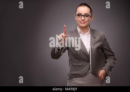 Young businesswoman pressing virtual button Stock Photo