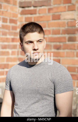Fashion model in front of brick urban wall Stock Photo - Alamy