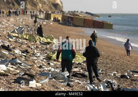 Branscombe Beach, Devon, England. People salvage contents from the striken and grounded container ship MSC Napoli washed up on the beach. 23.01.07 Stock Photo