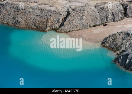 Bauxite mine, blue water caused by industrial runoff, minerals into local water, Linden town, Guyana, South America Stock Photo