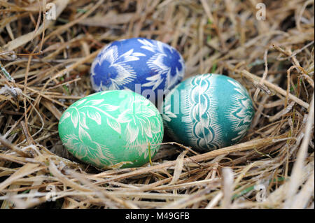 Traditional Polish hand painted Easter eggs outside on frozen grass from the Augustow region Stock Photo