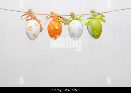 Easter eggs decoration. Eggs hanging on gray background Stock Photo