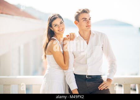 Attractive couple looking at amazing sea view.Enjoying sun and sunny weather and breathing in fresh ocean air.Enjoying moment outside.Two people shari Stock Photo