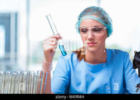 Young student working with chemical solutions in lab Stock Photo