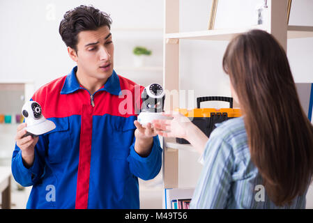 Client getting securty camera installed at home by contractor Stock Photo