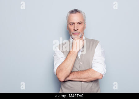 Close up portrait of qualified serious strict pensive clever head on big company thinking over new start-up in his business rolled-up sleeves white sh Stock Photo