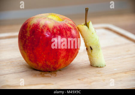 Removing apple's core on a wooden table Stock Photo