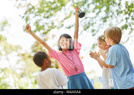 Cheering girl with trophy at the award ceremony after the competition Stock Photo