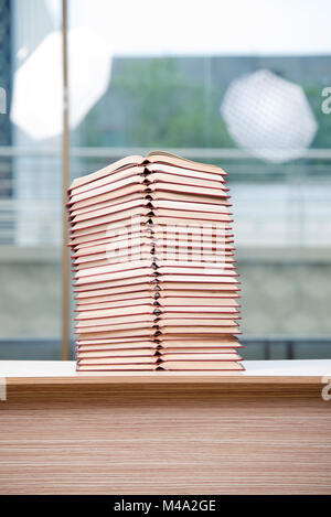 Stack of books arranged the office desk Stock Photo