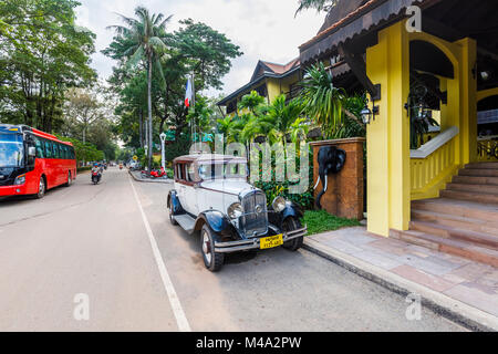 Classic light blue vintage Citroen car with large round headlights parked outside the Victoria Angkor Resort & Spa Hotel, Siem Reap, Cambodia, SE Asia Stock Photo