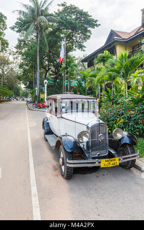 Classic light blue vintage Citroen car with large round headlights parked outside the Victoria Angkor Resort & Spa Hotel, Siem Reap, Cambodia, SE Asia Stock Photo