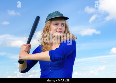 Young caucasian woman with baseball bat and cap Stock Photo