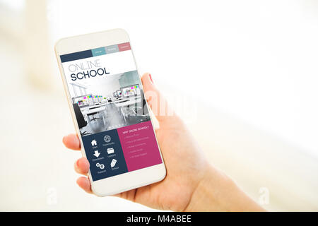 Woman holding a pink gold generic smartphone showing online school Stock Photo