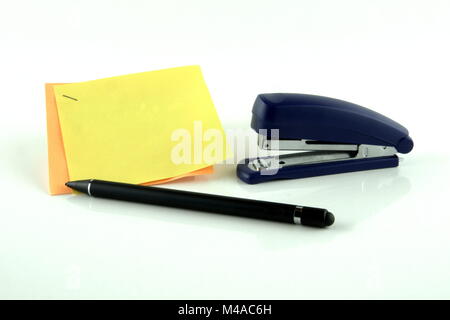 Sticky notes with pen and stapler isolated against a white background. Stock Photo
