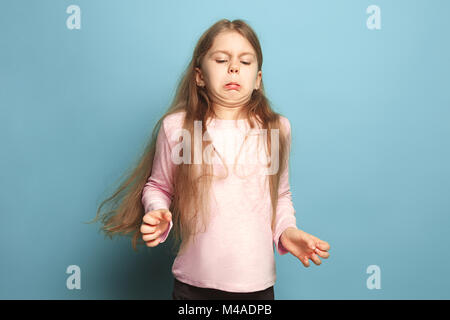 The disgust. Teen girl on a blue background. Facial expressions and people emotions concept Stock Photo