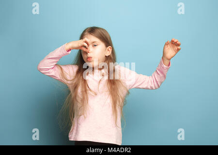 The disgust. Teen girl on a blue background. Facial expressions and people emotions concept Stock Photo