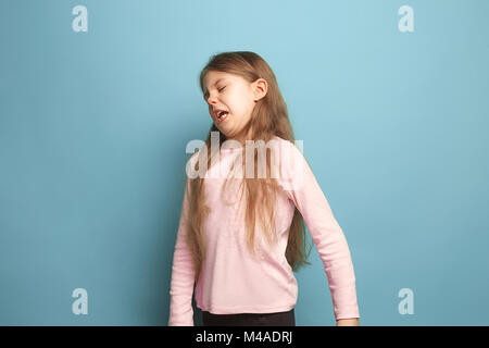 The disgust. Teen girl on a blue background. Facial expressions and people emotions concept Stock Photo