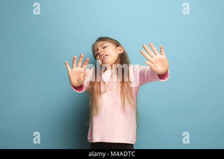 The disgust. Teen girl on a blue background. Facial expressions and people emotions concept Stock Photo