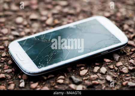 Close Up Of Dropped Mobile Phone With Cracked Screen Stock Photo