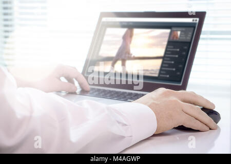 Photo editing. Professional editor retouching an image with laptop and imaginary software. Working in creative agency office. Stock Photo