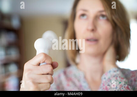 Mature Woman Experiencing Hot Flush From Menopause Using Electric Fan Stock Photo